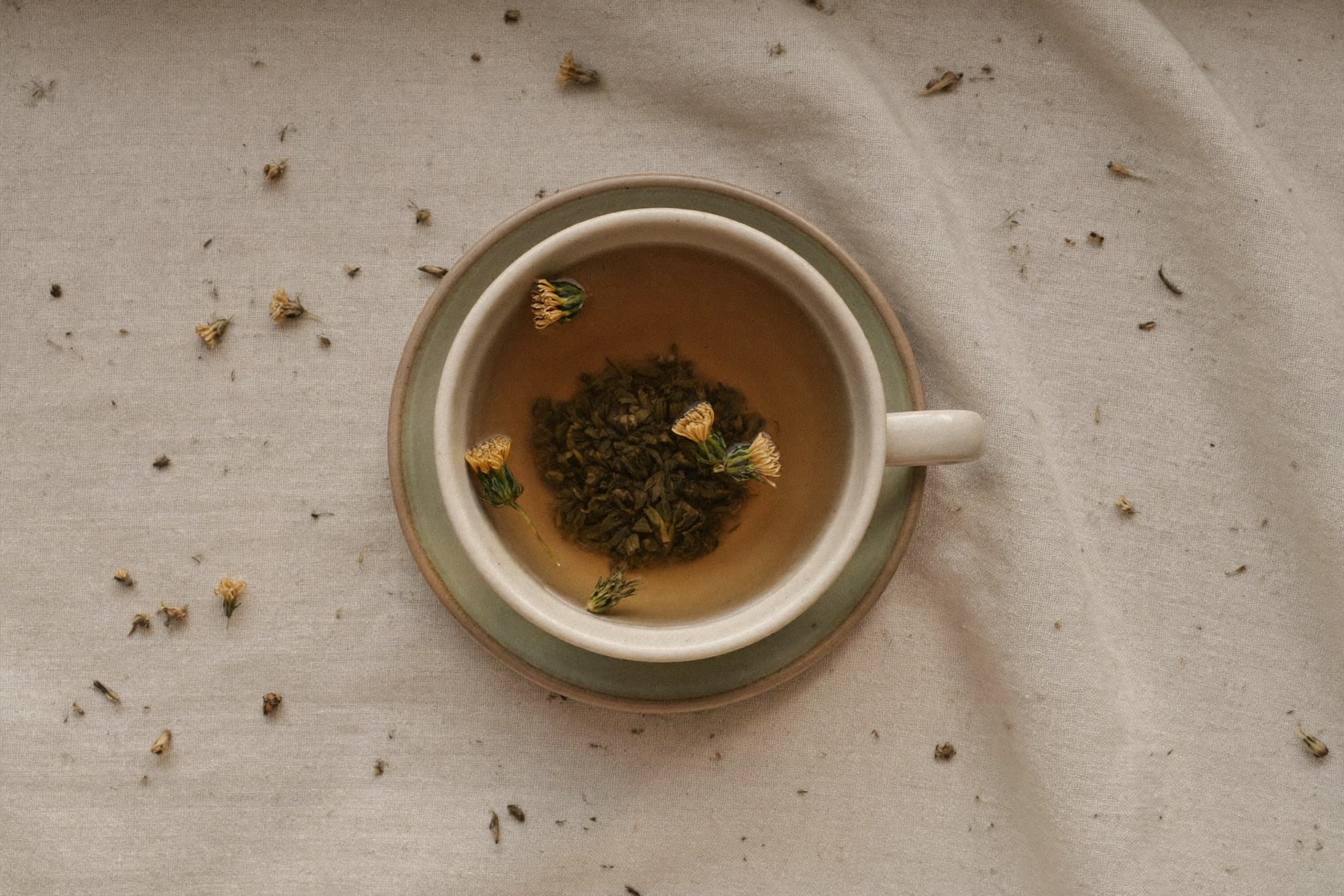 A cup of loose-leaf herbal tea seen from above
